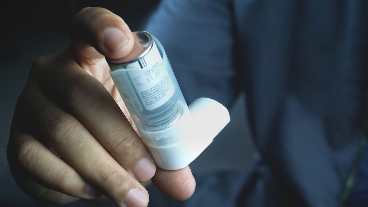 A closeup of a male hands holding asthma inhaler - Medical equipment concept; Shutterstock ID 2300931303; purchase_order: 7-9-24; job: Medical sustainability white paper ; client: Envalior ; other: 